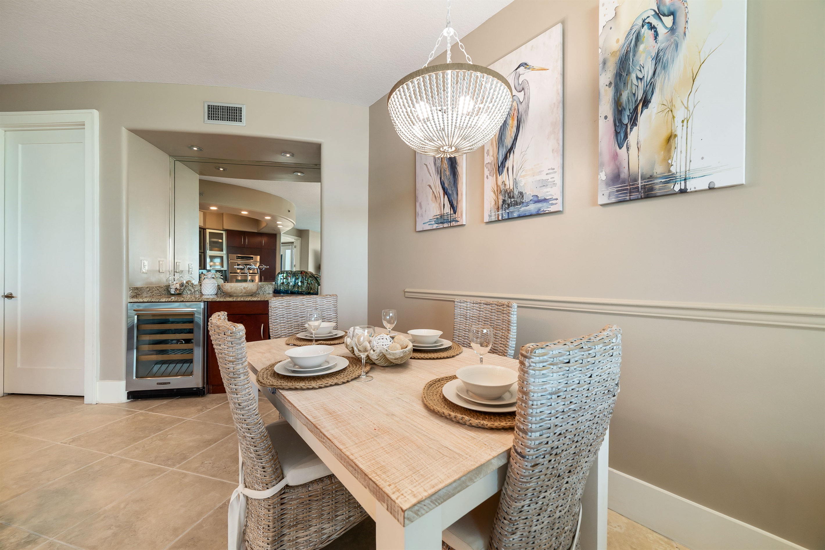 Artful accents elevate this dining space. The captivating mosaic wall art adds a touch of sophistication and visual interest, perfectly complementing the thoughtfully chosen tableware.