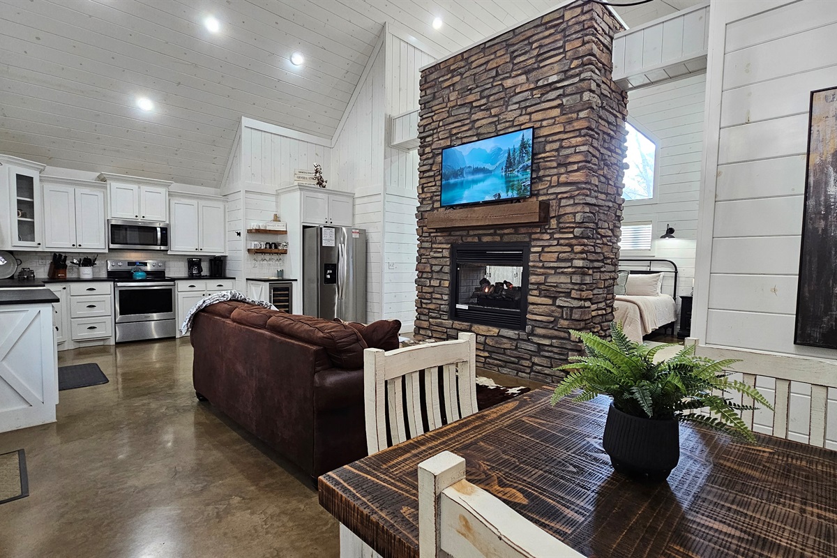 Living Room: Stylish space with stone accents, plush seating, and a cozy fireplace for relaxation!