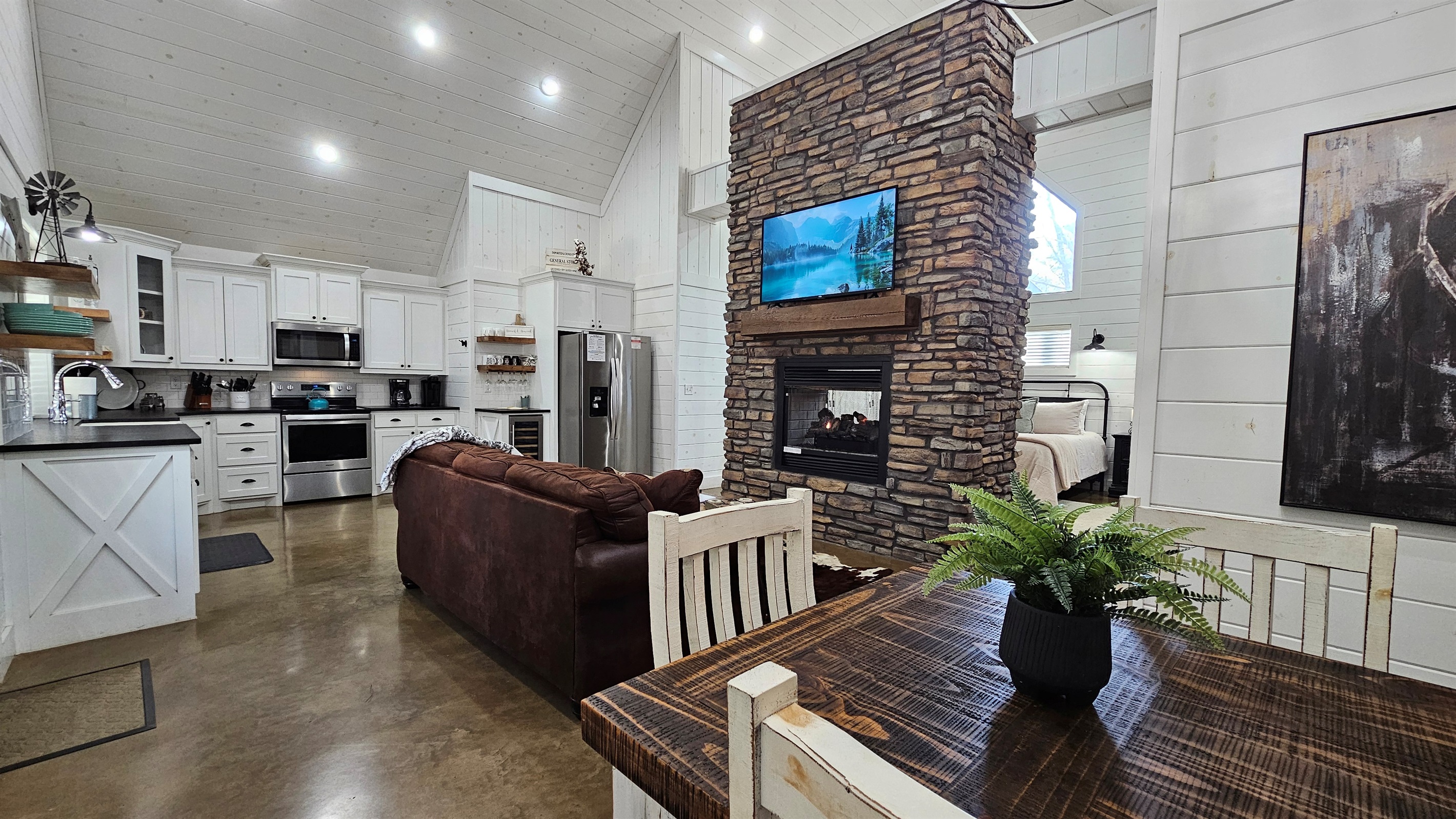 Living Room: Stylish space with stone accents, plush seating, and a cozy fireplace for relaxation!