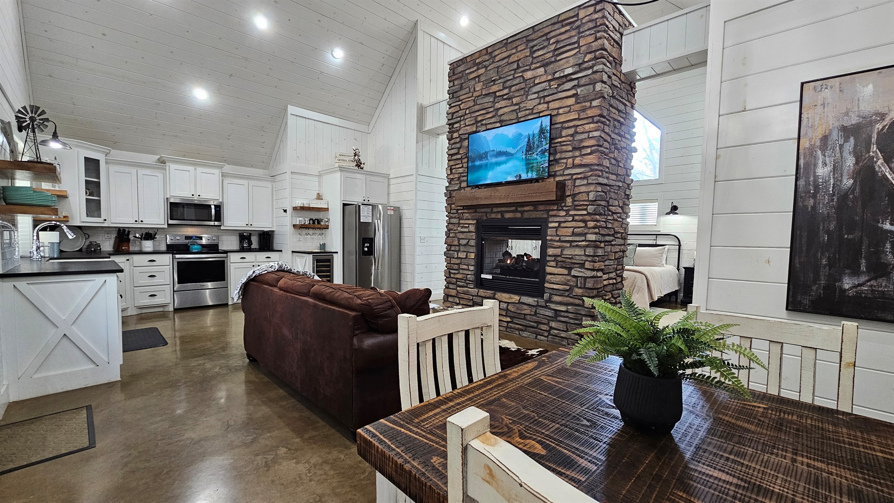 Living Room: Stylish space with stone accents, plush seating, and a cozy fireplace for relaxation!
