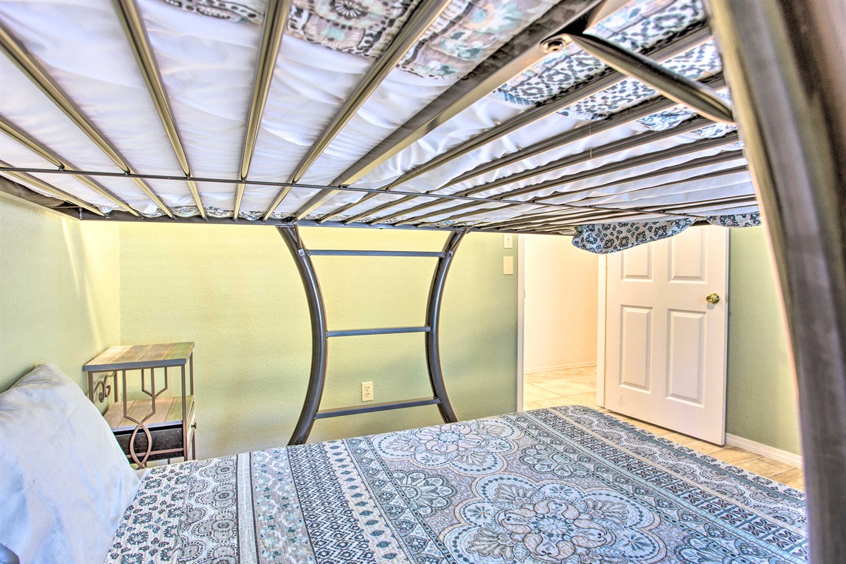 Green bedroom with full over full bunk bed