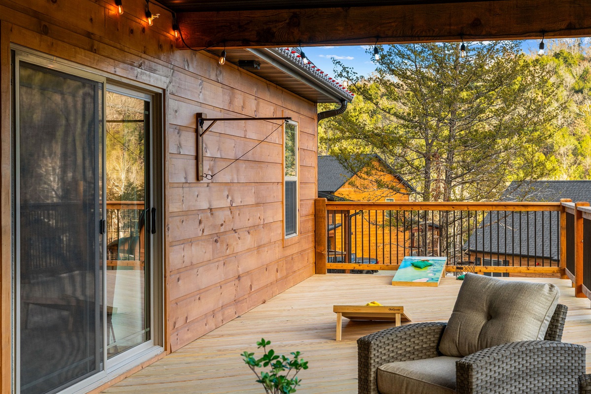 Covered deck with comfortable seating to enjoy the outdoors.