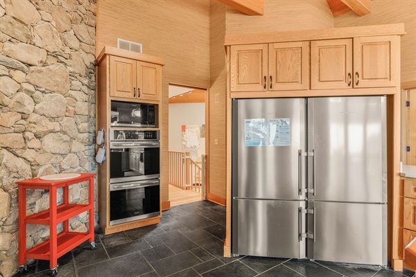 Two full size refrigerators (side by side), 2 ovens, microwave
