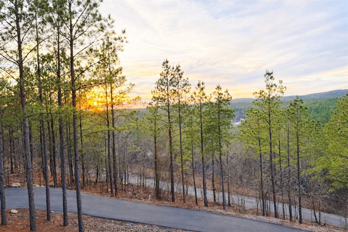 Paved driveway for the property with parking off the sides of the drive on the way up and at the top. 