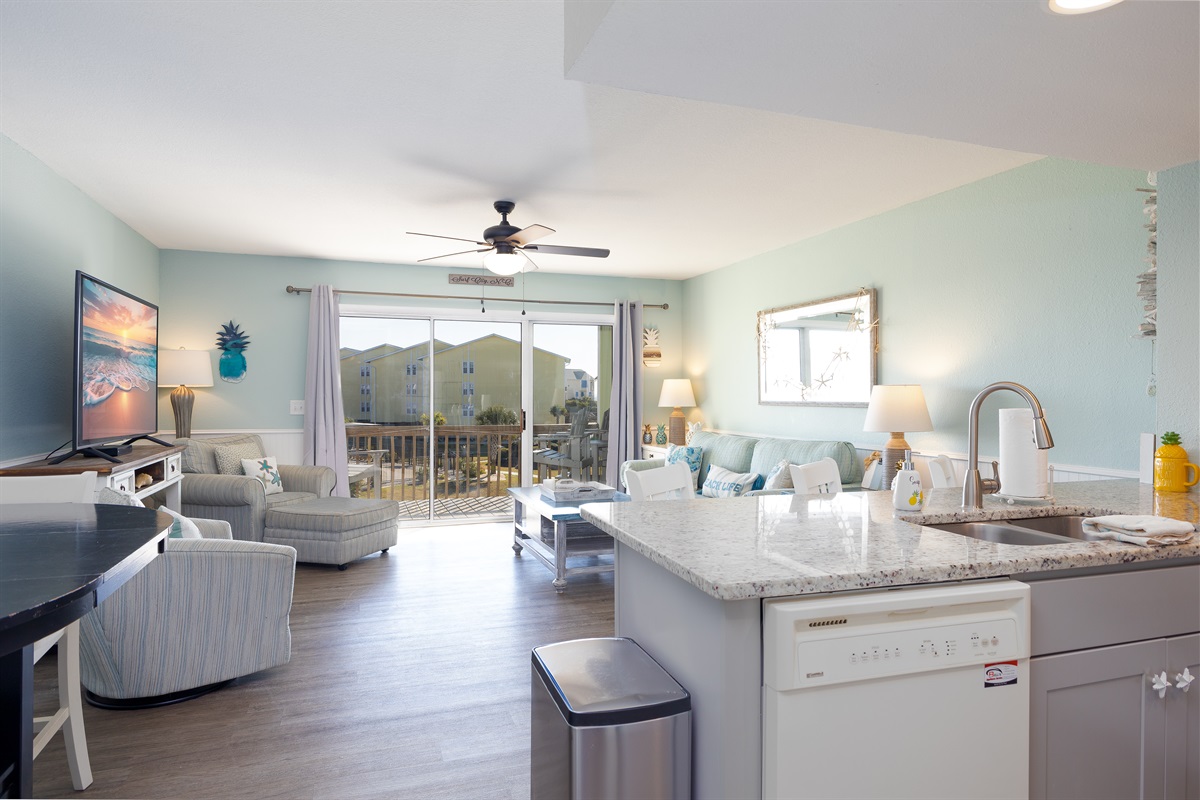 Enjoy an open flow from the kitchen into the sunlit living space, perfect for relaxing and gathering after a day at the beach
