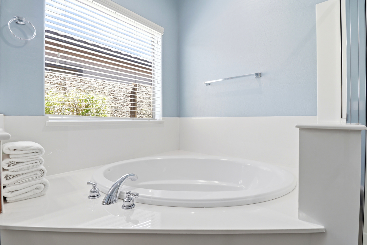 Soaking tub with fresh towels nearby and a simple spot to unwind after the day.
