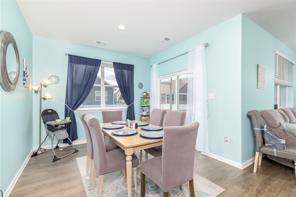 Spacious dining area for six—ideal for family meals or game nights. Includes a toddler high chair, kids’ activity shelf, garden views, and sliding doors to the backyard and screened porch.