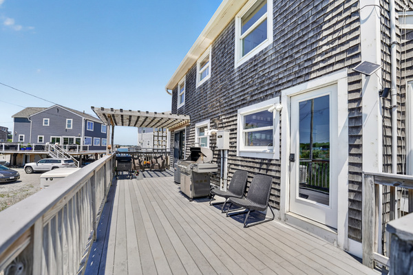 Spacious outdoor deck provides an inviting place to lounge, enjoy the coastal air, and spend time together.