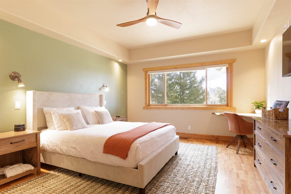 Secondary bedroom featuring a queen sized bed and expansive views of the beautiful scenery