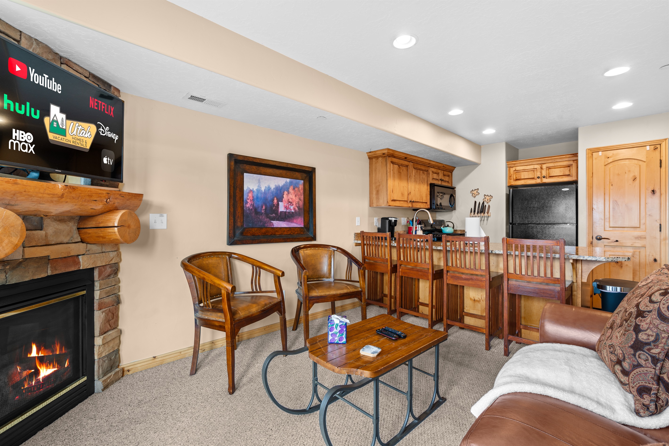 Gather by the fireplace and enjoy the open-concept flow into the kitchen and dining area.