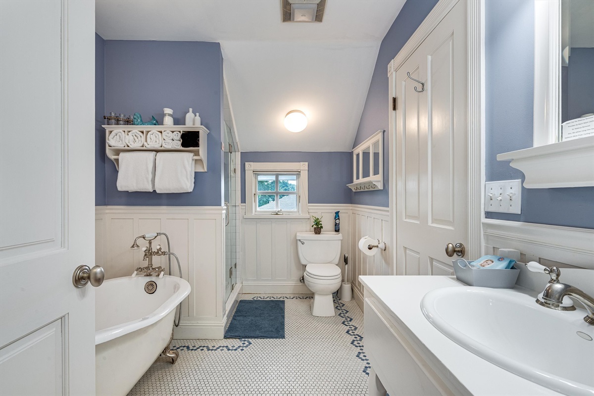 Glass door shower behind towels on left