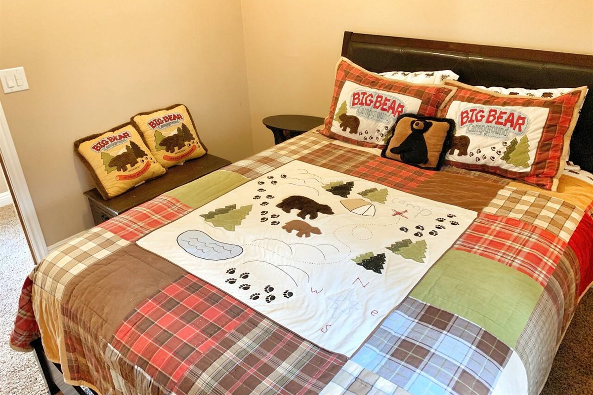 Bedroom #2: Bedroom with a queen bed, carpet floor, & rustic decor.