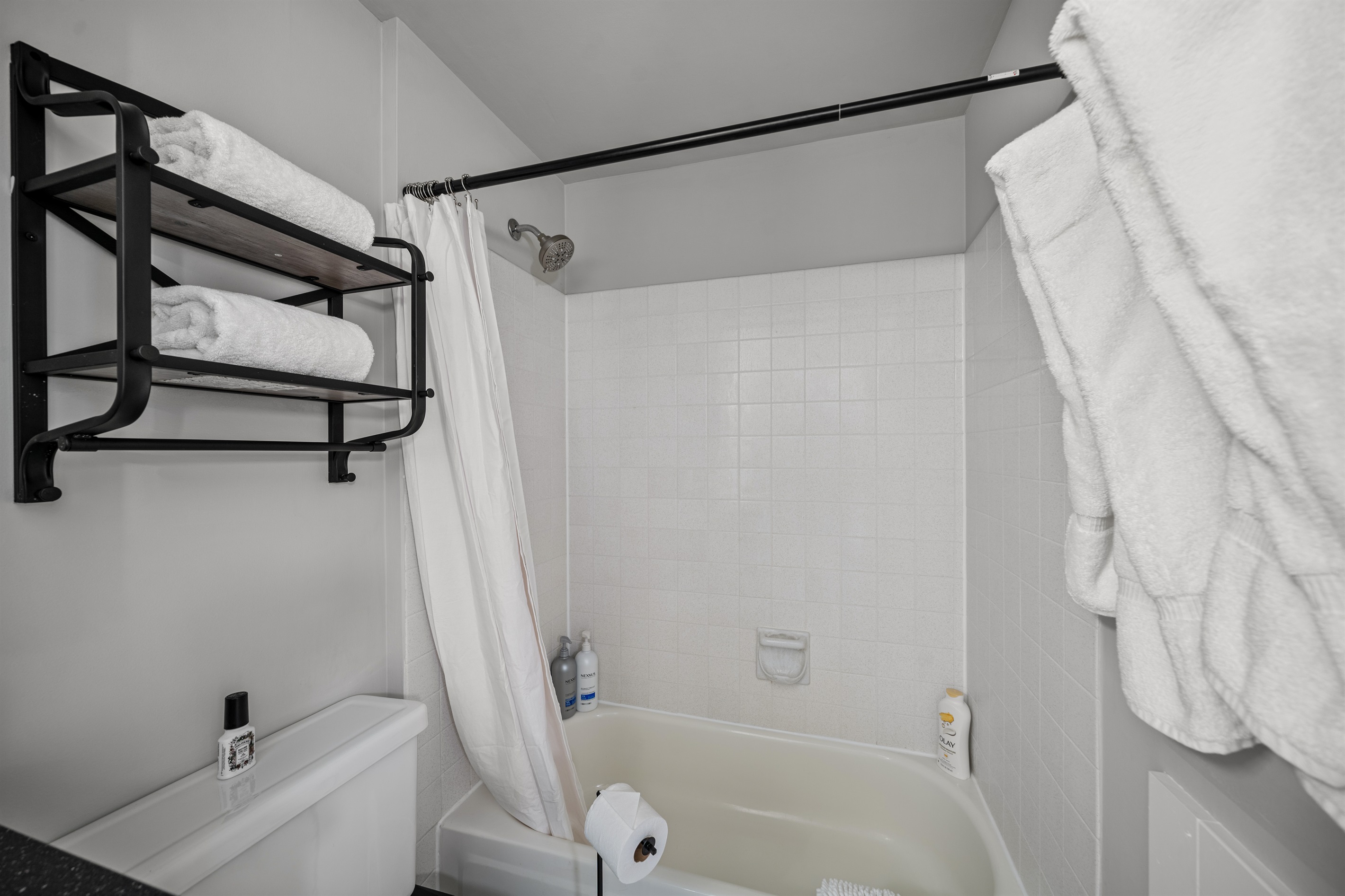 A tub-shower combination with plenty of towels