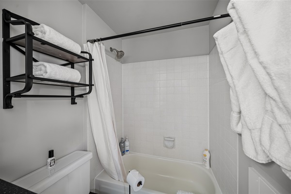 A tub-shower combination with plenty of towels
