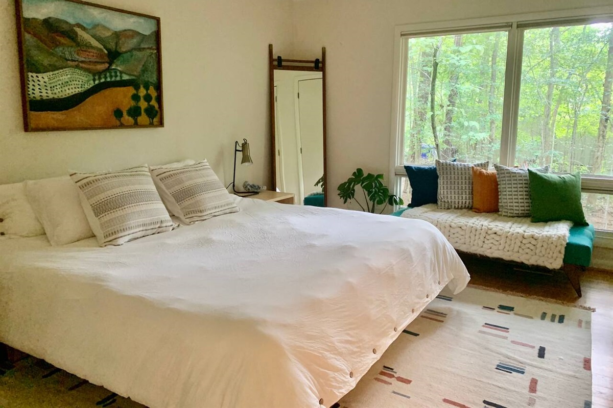 Handwoven rug by Lulu & Georgia. Peaking at you from the mirror: Two expansive closets to store your luggage &mdash; or your entire wardrobe. 