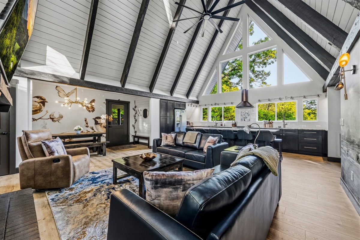 Kitchen, dining, living — all under the A-frame, all close enough to stay connected.