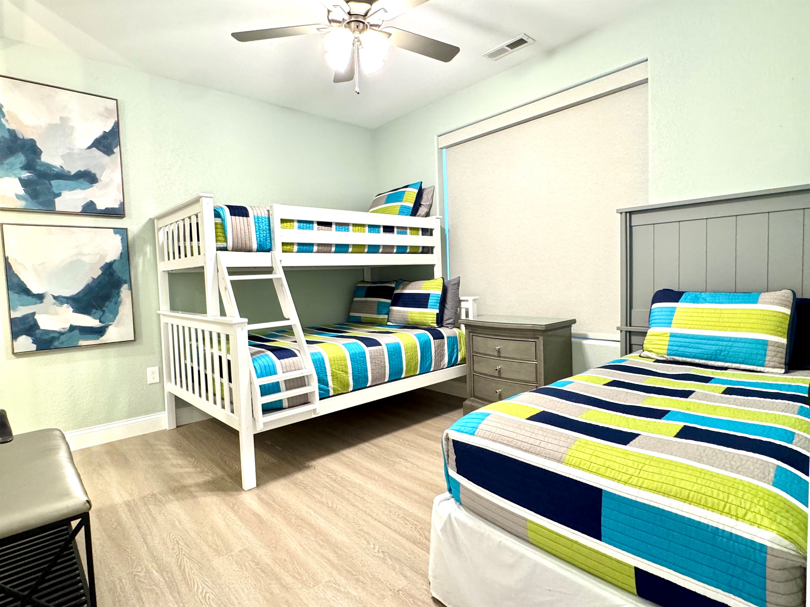 Guest Bedroom 3 has a twin bunk bed over a full bed and another twin bed, closet, and private en suite bathroom.