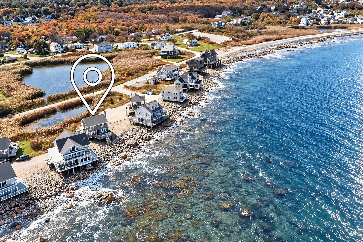 Aerial view showcasing this exceptional beachfront location with direct access to the shoreline and panoramic coastal views.