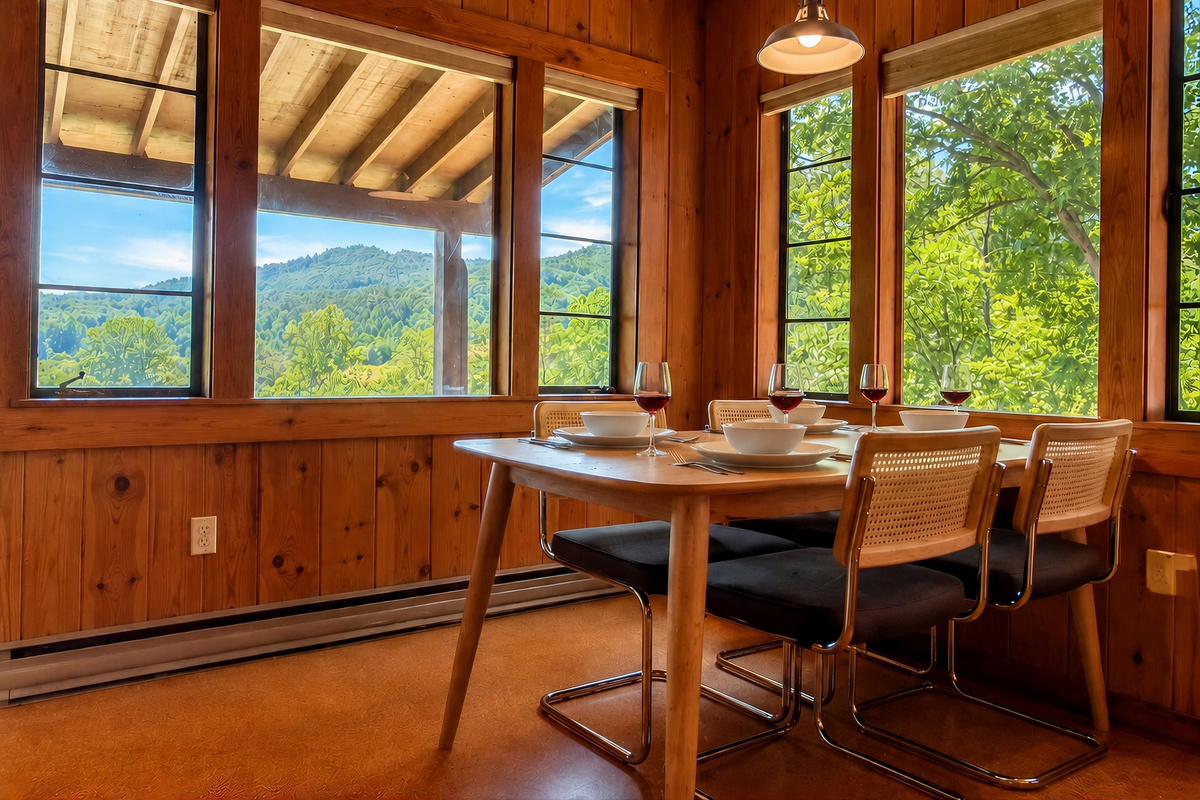 The dining area seats four and overlooks Deep Creek and Sharp Top mountain in the distance.