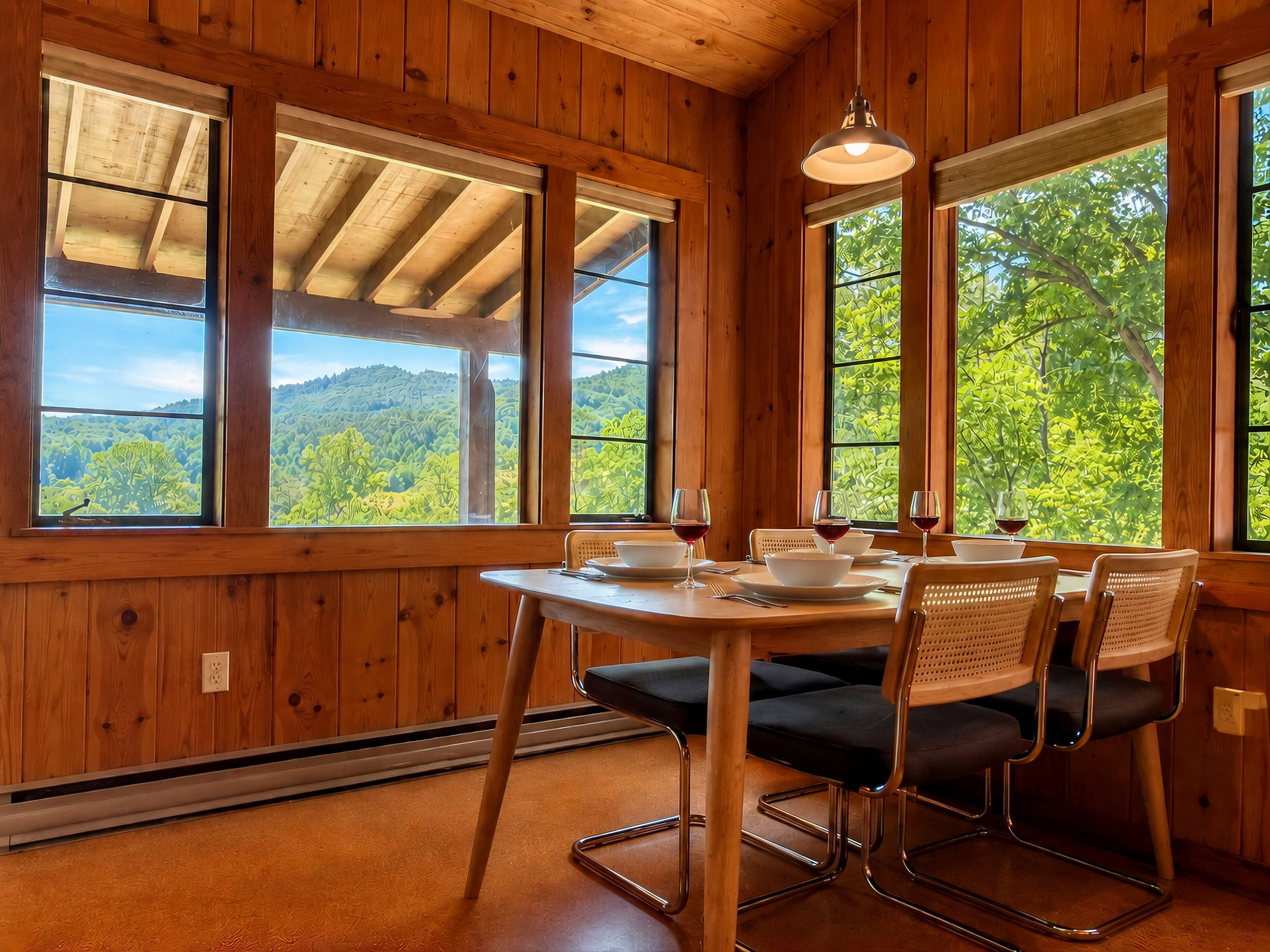 The dining area seats four and overlooks Deep Creek and Sharp Top mountain in the distance.