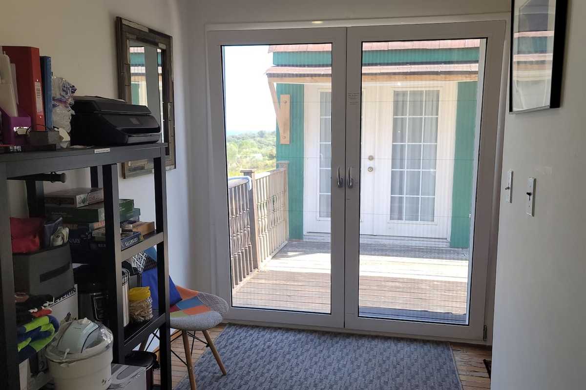 Common area for both apartments with french  doors that lead to a shared balcony where one can sit and enjoy the beauty, use the BBQ grill, or hang  clothes to dry.  The doors will vent to let in fresh air and have sliding screens as well. 