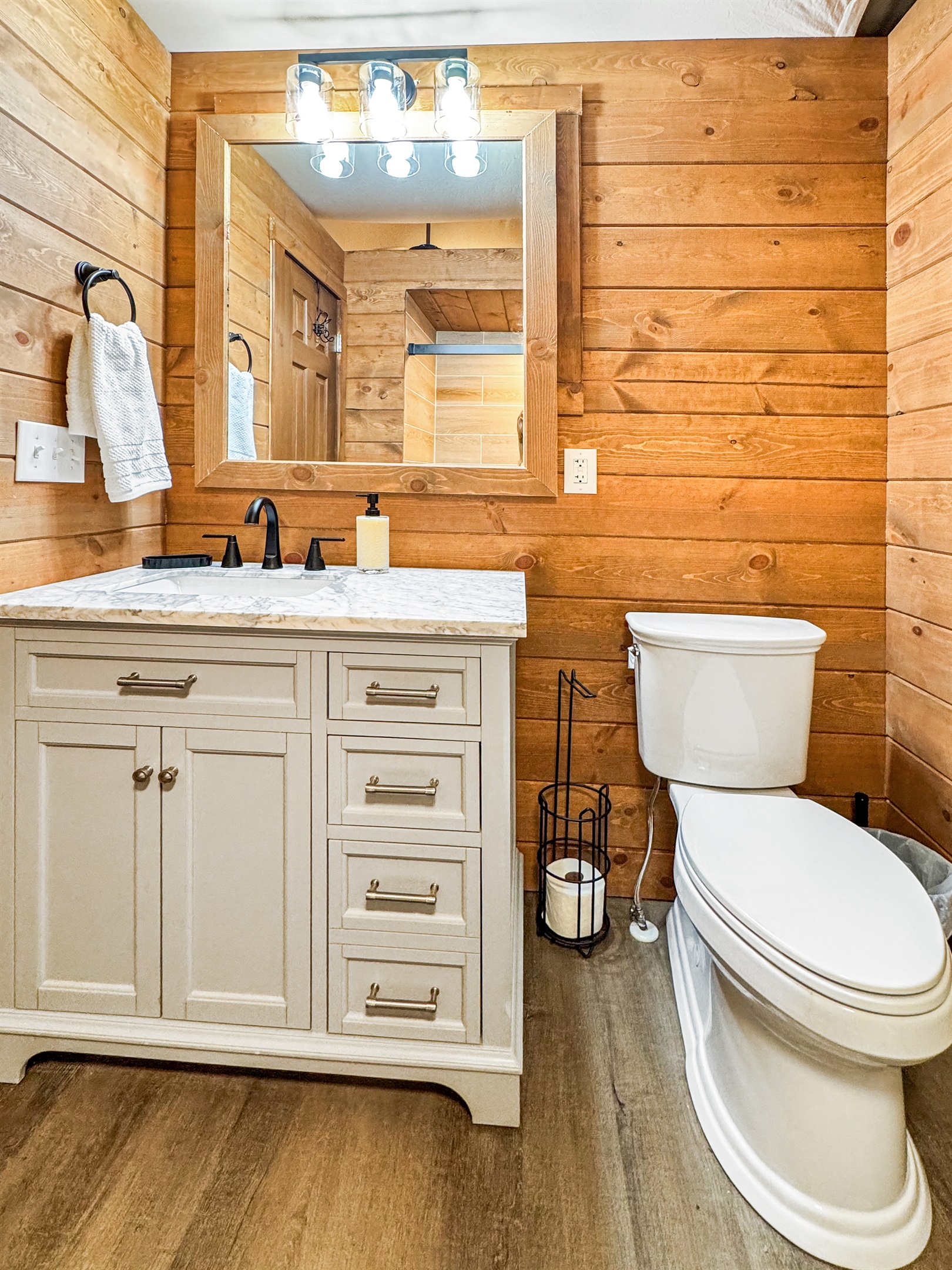 Bathroom Bliss: Enjoy a stylish retreat with modern fixtures and natural wood accents!