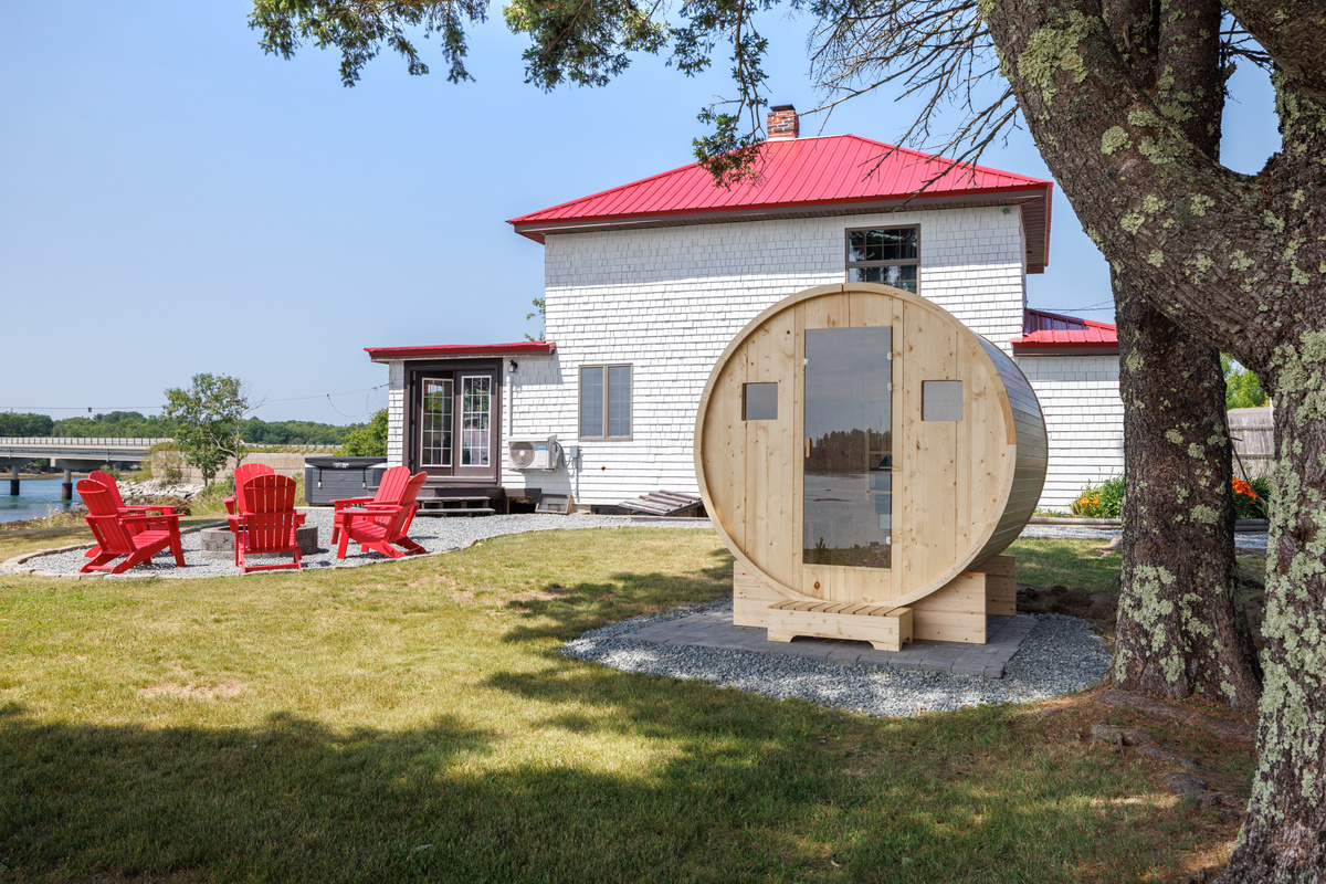Step inside the barrel sauna — cedar walls still warm from the last session, your private waterside spa five steps from the bay.