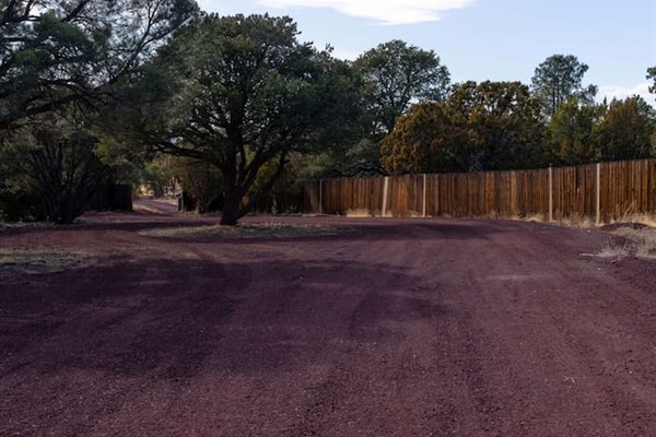 Follow this charming rustic driveway lined with juniper trees and endless sky, leading you to a cozy retreat tucked away in nature. Breathe in the fresh air, soak in the serenity, and let the adventure begin!