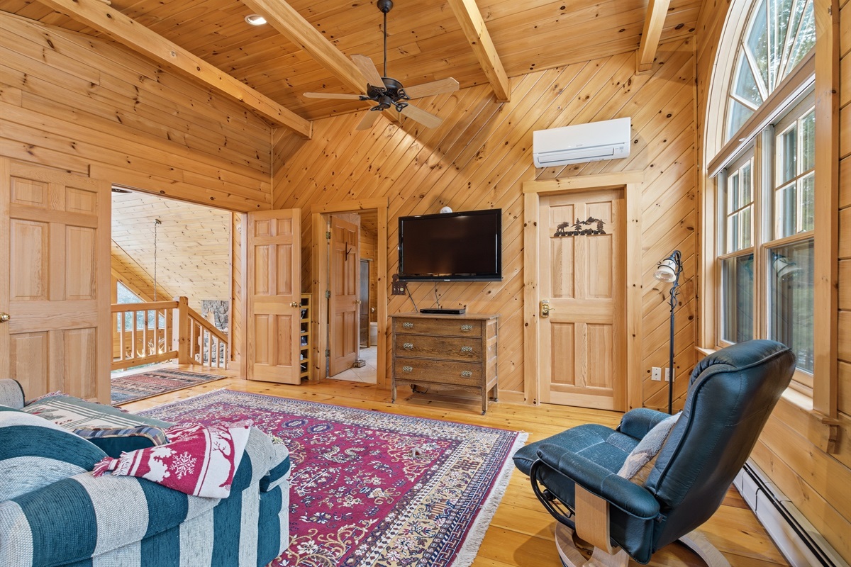 Spacious upper-level primary suite with a king bed and peaceful mountain cabin feel.