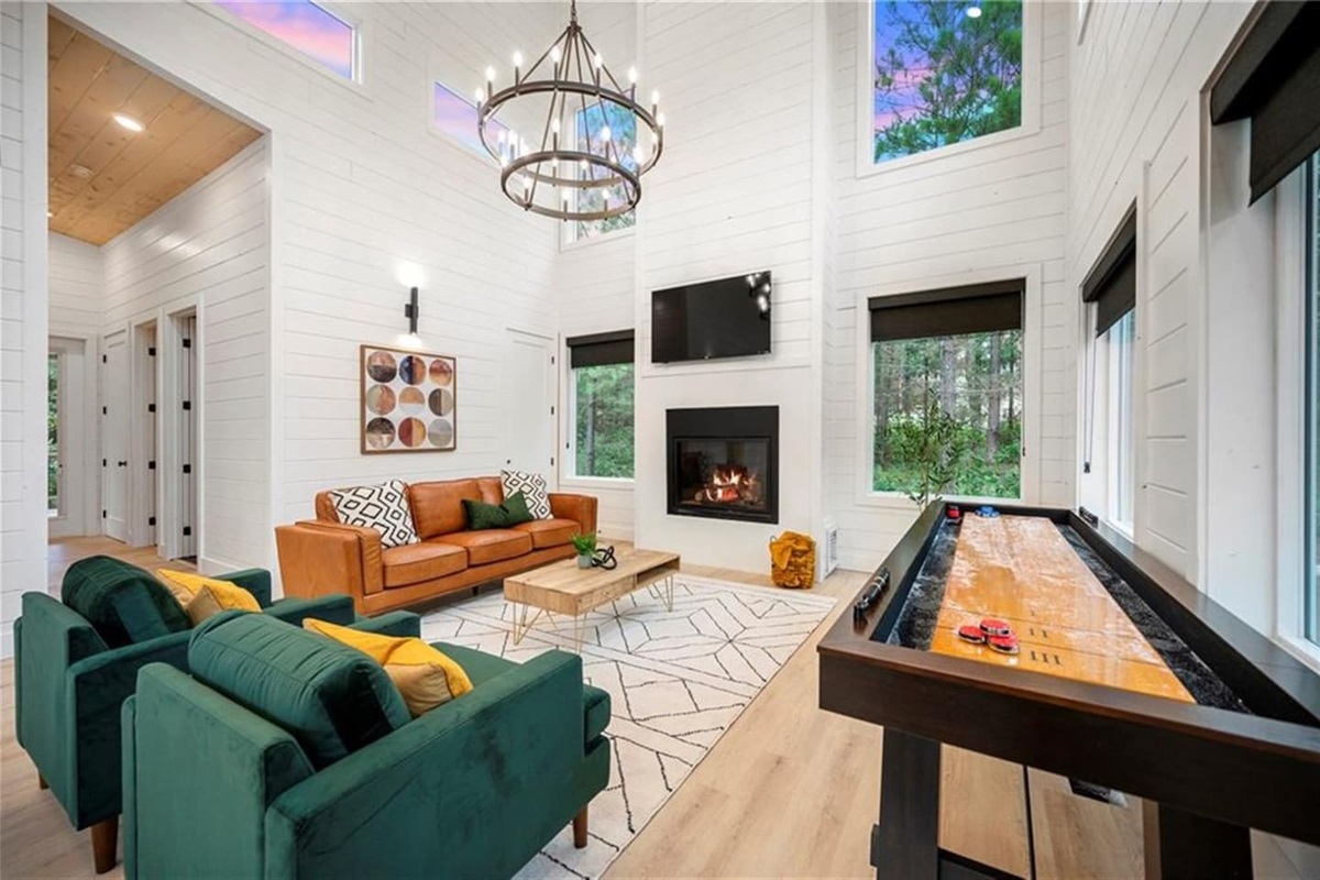 Gather in the heart of the cabin—cozy up by the fireplace, watch a movie, or challenge each other to shuffleboard right in the living room.
