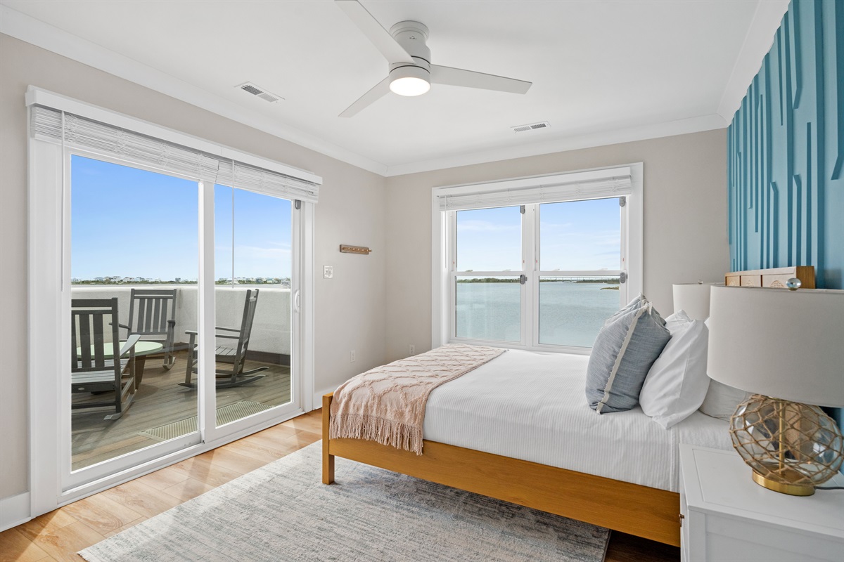 Bedroom (2nd floor)Private 2nd-floor queen bedroom featuring balcony access and stunning waterfront views