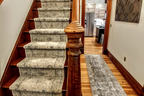 The farm house's original historic staircase leads to three bedroom suites on the upper level