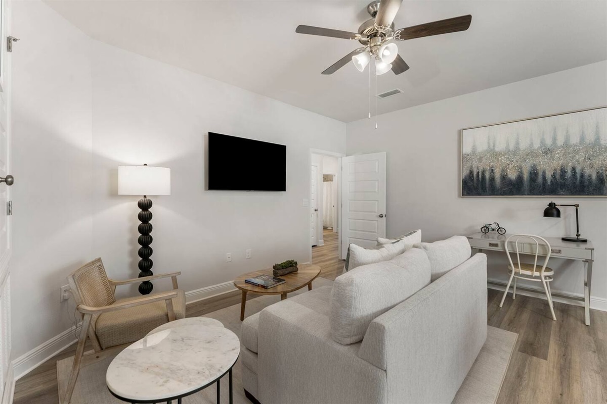 Additional entertainment area with comfy couch and smart TV.