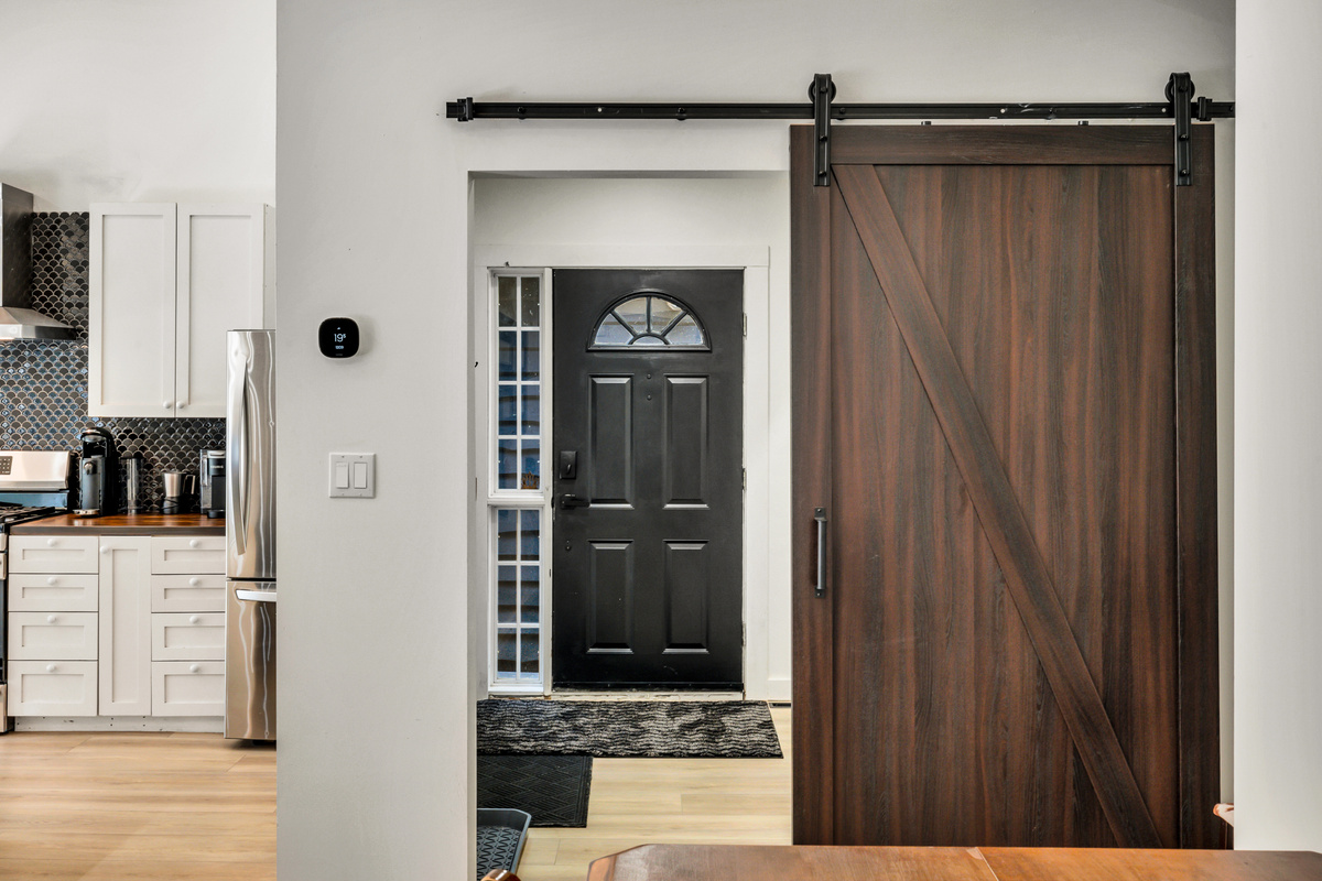 Thoughtful details like the sliding barn door add warmth and character to the bright, modern interior.