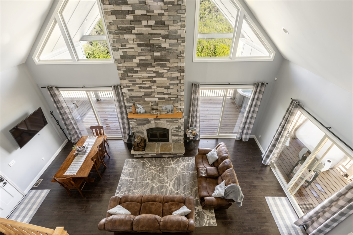 Cozy living room with a wood burning fireplace and stunning view of mountains
