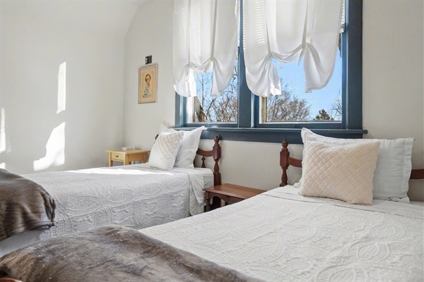 East bedroom with nightstands and charging station