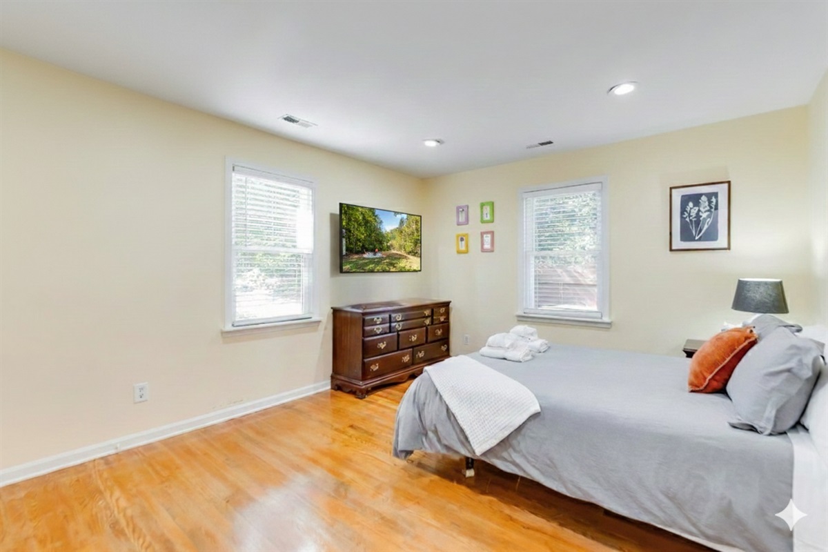 Upstairs Queen Bedroom 2: Enjoy warm sunlight and charming decor in your serene retreat!