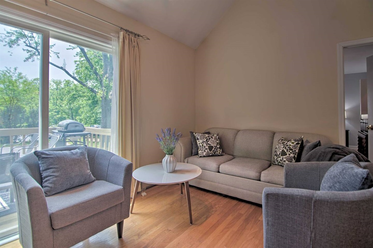 3Bd Unit: The living room access the private deck and is bright and airy.
