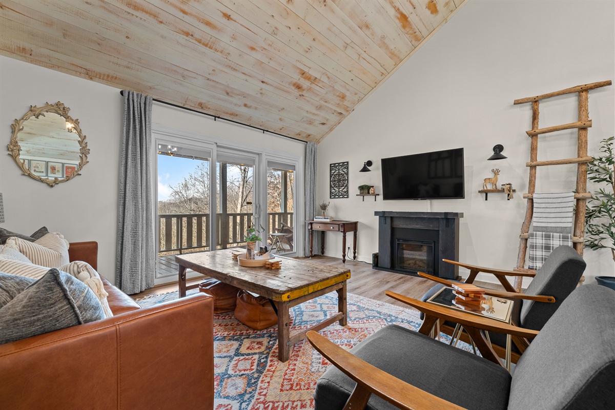 Main living room with view of outdoor balcony.