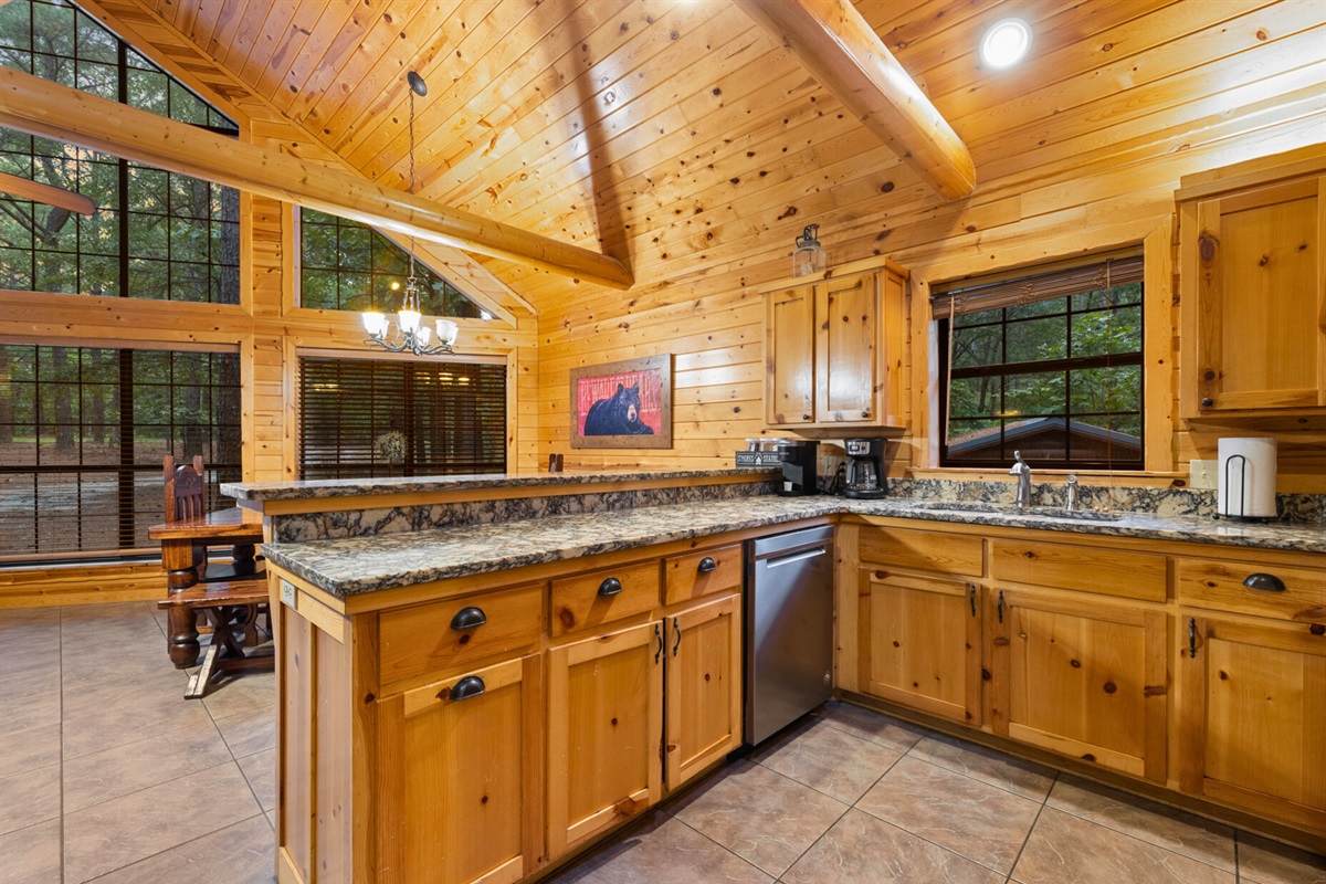 Spacious kitchen with island, vaulted ceilings, and natural light