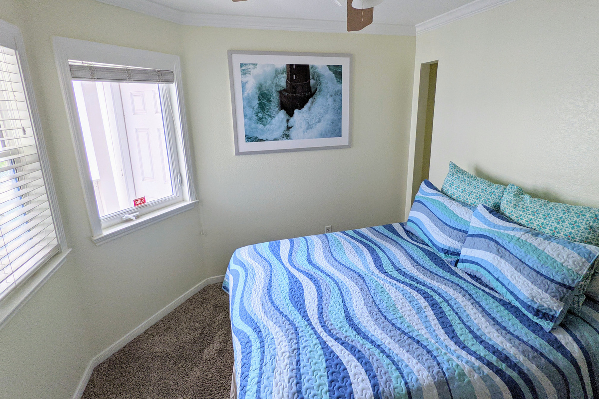 Guest bedroom with queen-sized bed.