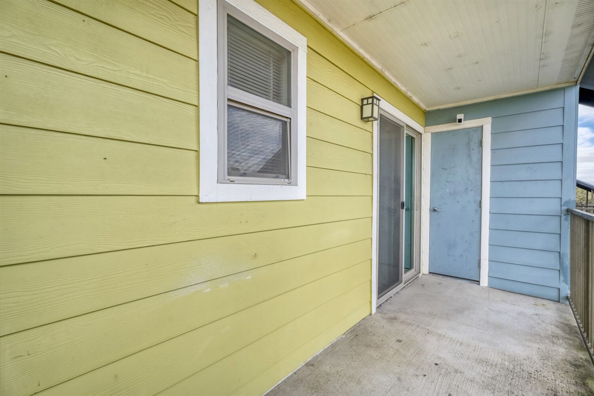 Bright and cheerful balcony with colorful walls and space to relax outdoors.