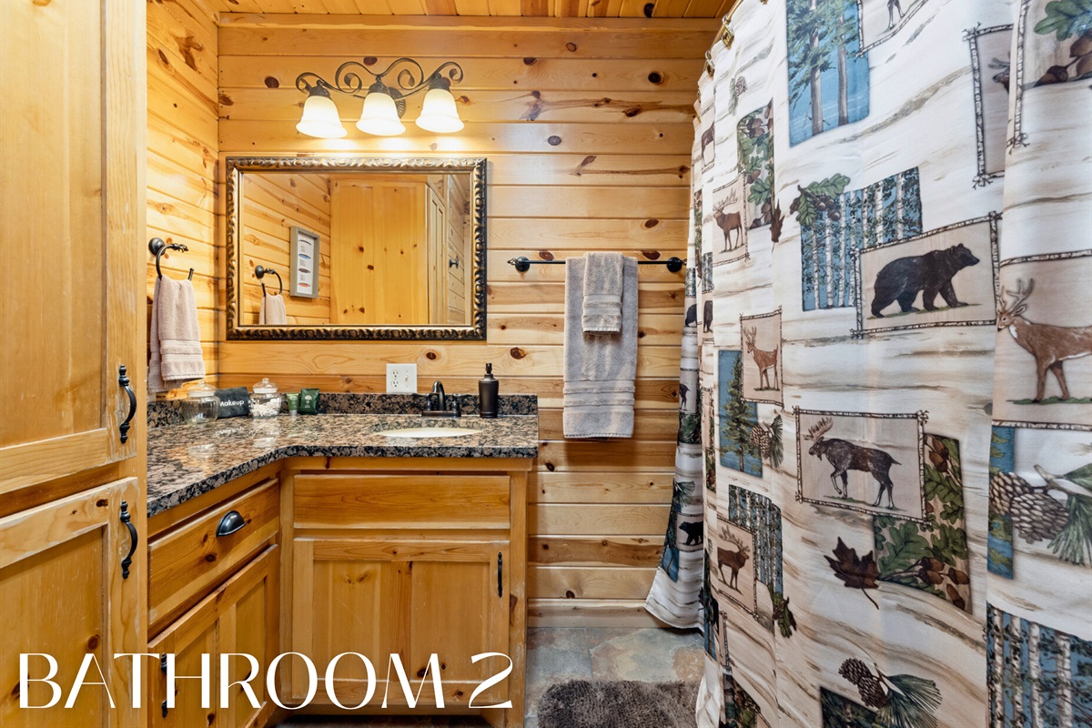 Bathroom 2 with wood cabinets and rustic decor.