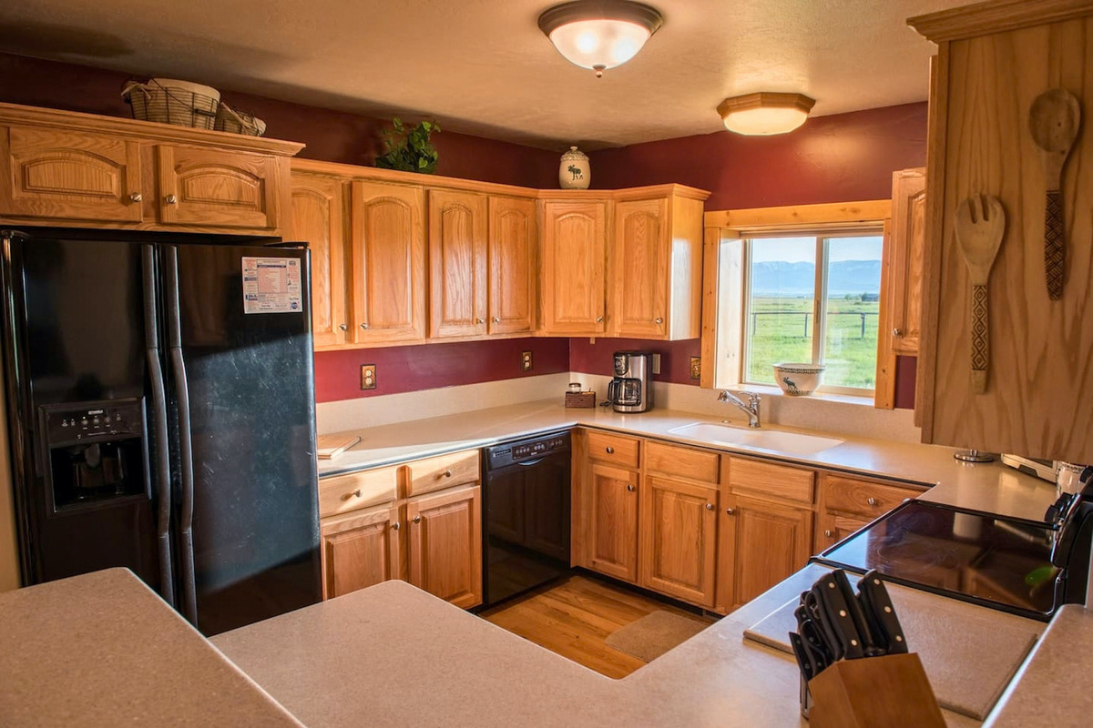 The kitchen not only provides a beautiful view of nature, but also plenty of space for cooking and baking.