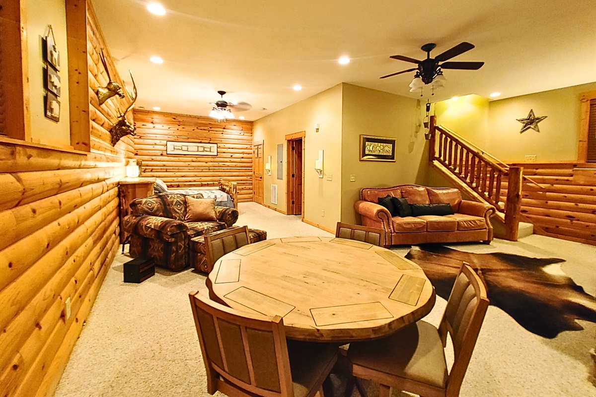 Open Living Area downstairs with sleeper sofa & poker table.