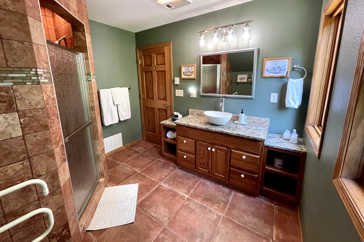 Spacious bathroom granite countertops two large windows brings a lot of light overlooking firepit. Large Italian Marble walk in shower, provided toiletries   *note this is the upper loft level must take stairs to access* bedroom is main entry level * 
