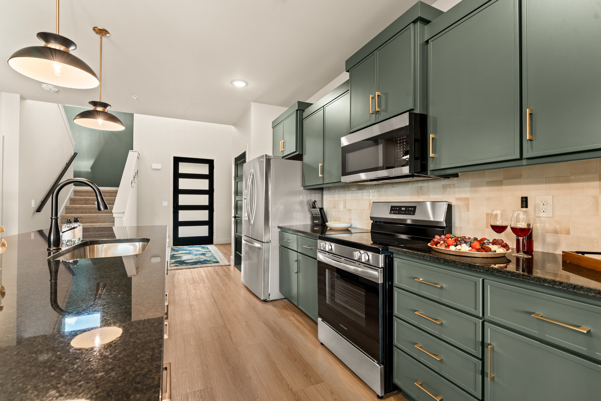 Fully equipped kitchen with stainless steel appliances and plenty of counter space for preparing group meals.