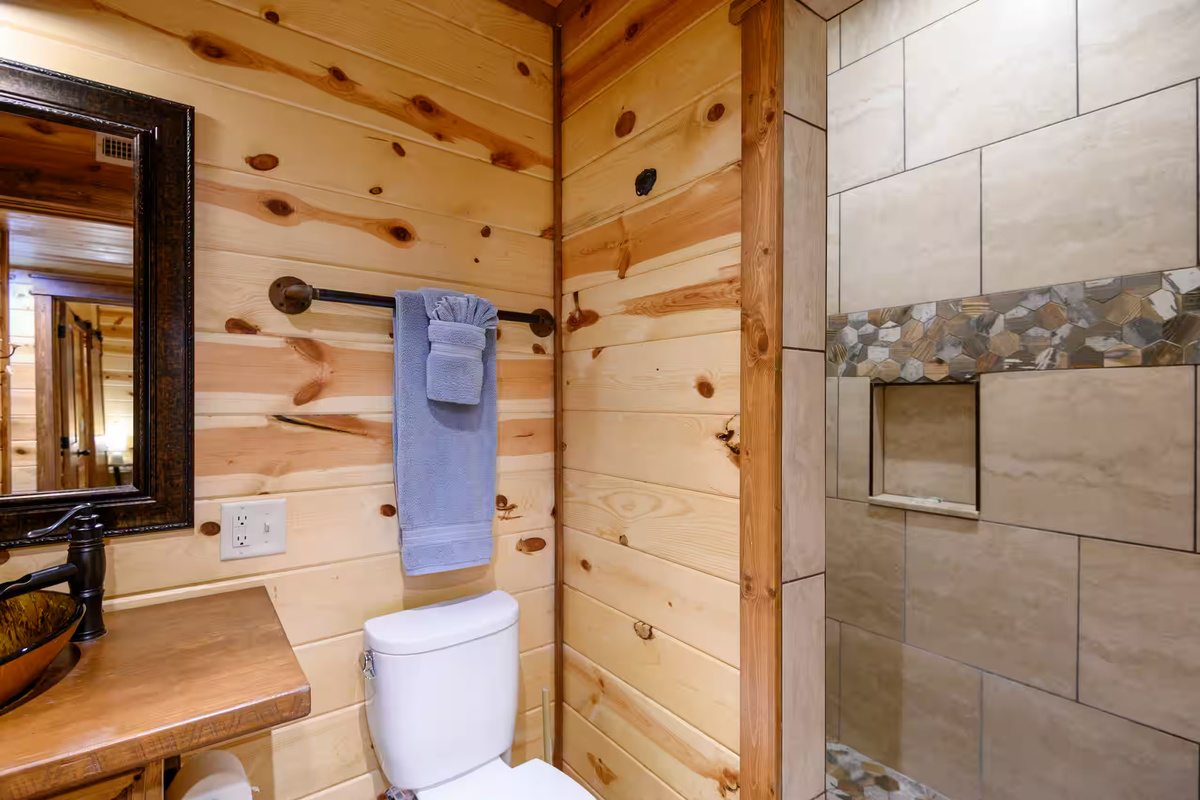 Bathroom Retreat: Rustic charm with elegant fixtures and a spacious shower for ultimate relaxation!