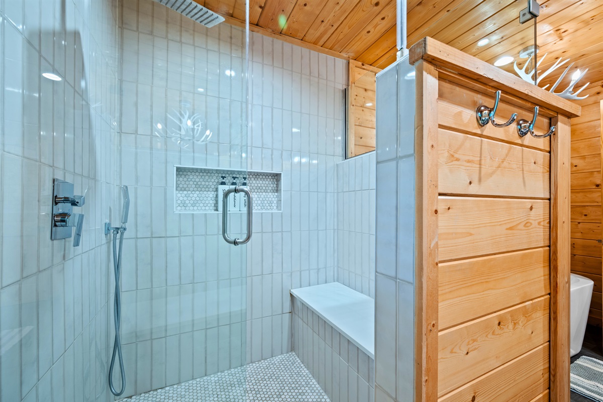 A glass walk-in shower brings a modern touch while keeping the space open and bright.