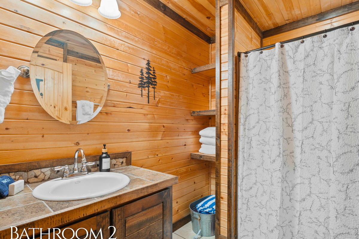 A chic vanity and full tub/shower combo make Bathroom 2 just right for freshening up after a day in the great outdoors.